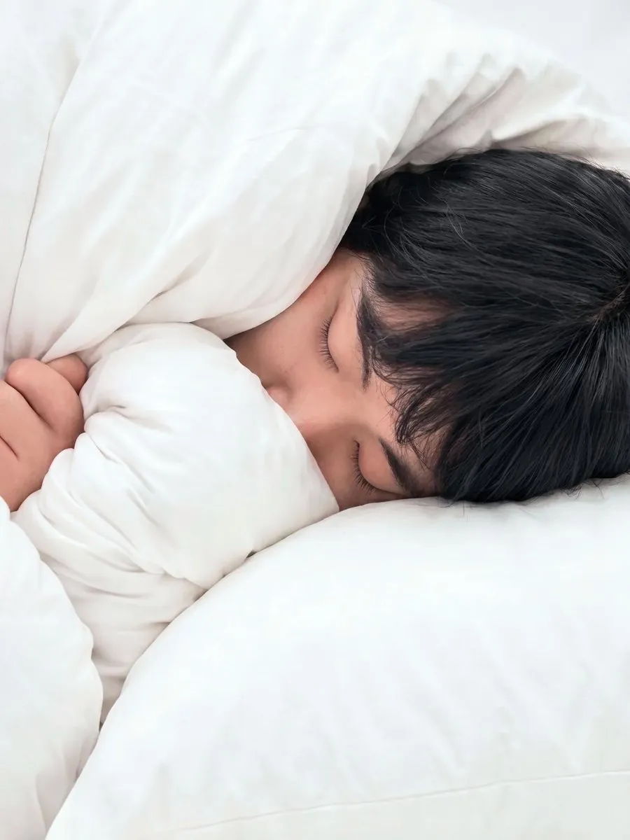 QUIET HOUR — sleeping portrait wrapped in white bedding with calm stillness